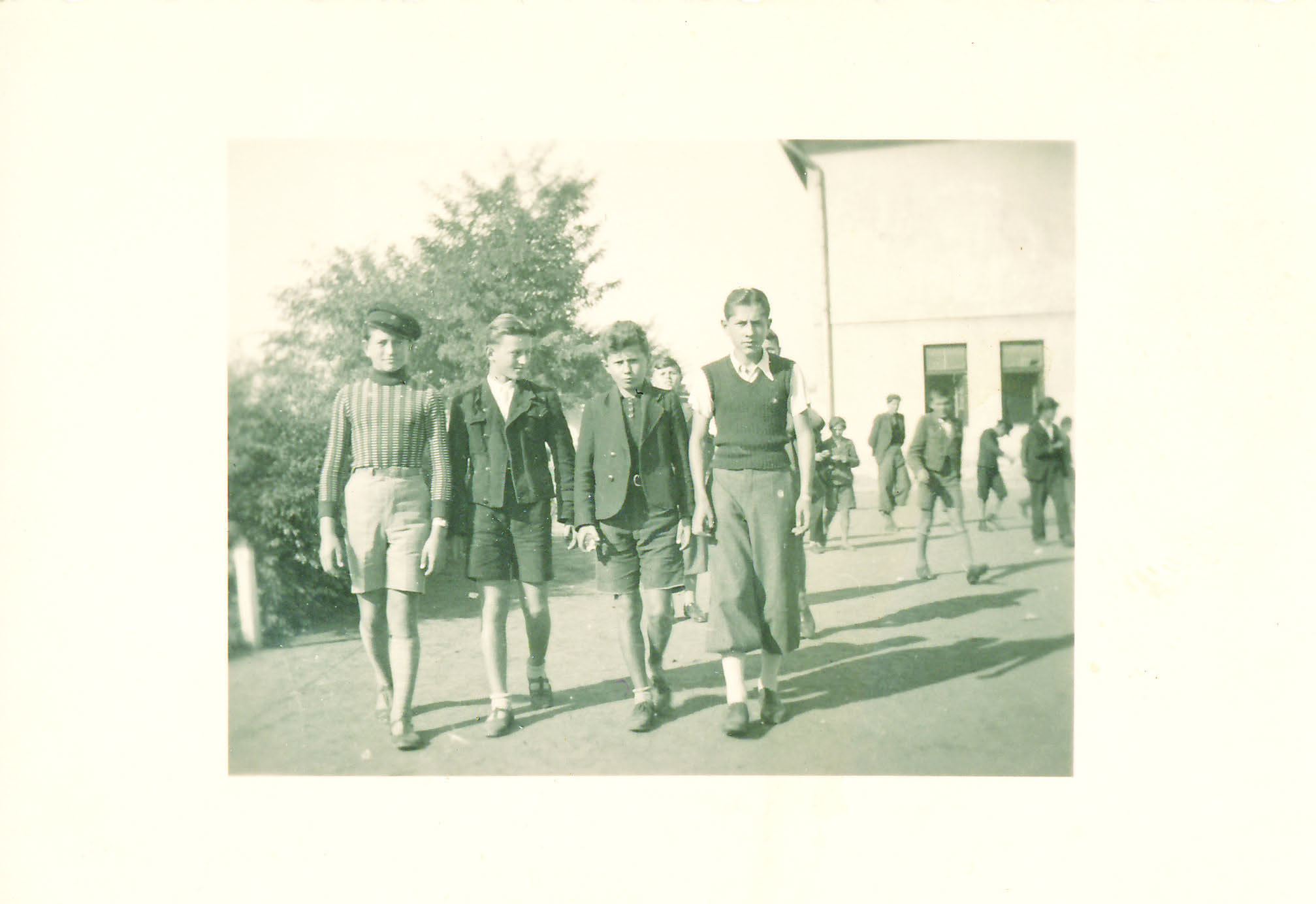 16. Julije kao pučkoškolac s prijateljima na školskom odmoru u dvorištu.